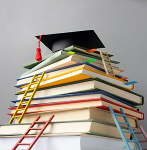 free photo low angle of stacked books, a graduation cap and ladders for education day (1)
